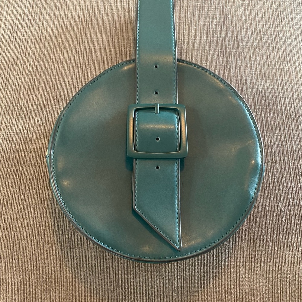 Super cute greenish blue wristlet with a buckle strap.